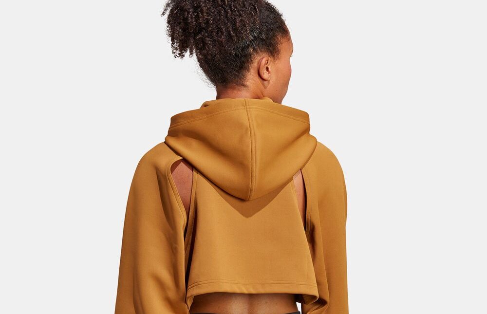 Back view of woman wearing a brown cropped hoodie.