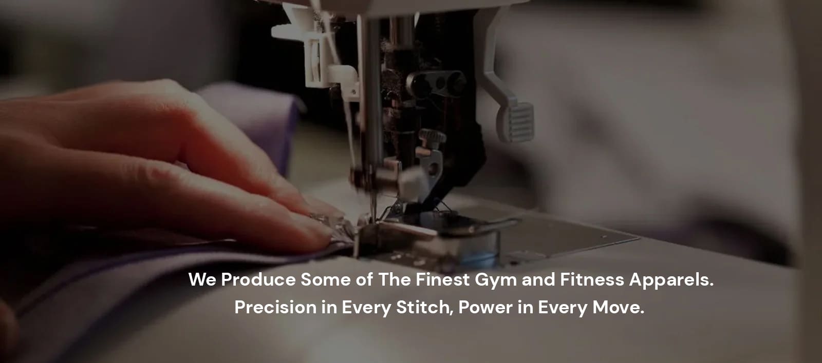 A gym shirt on a table with a stitching machine visible.