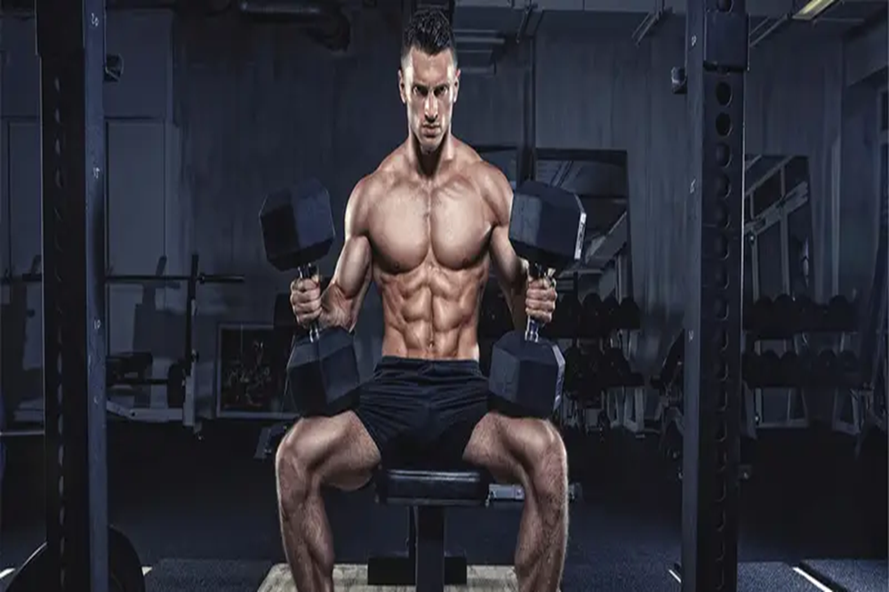 Muscular man performing seated cable row exercise in gym