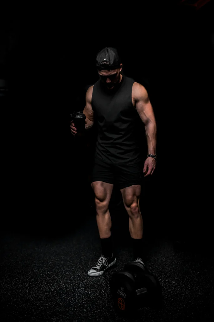 Gym Clothes Manufacturer in France featuring a male athlete wearing black custom workout apparel in a professional gym
