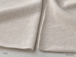 Best fabric for t shirts close-up showing the front and reverse knit surfaces of soft cotton single jersey fabric.